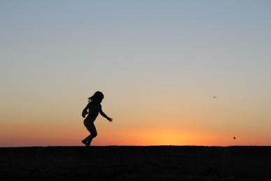 Running girl shown in silhouette