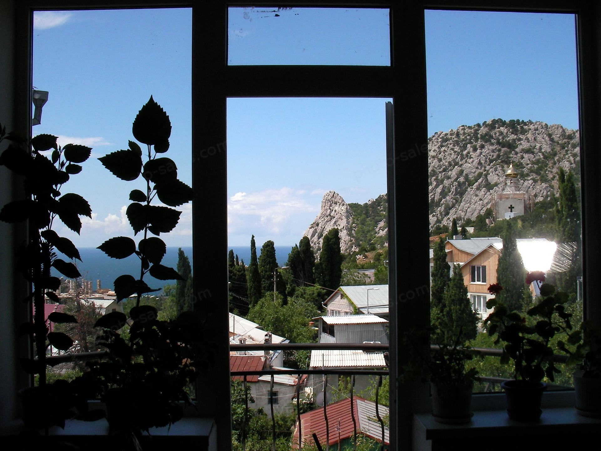 Window view of the sea and mountains